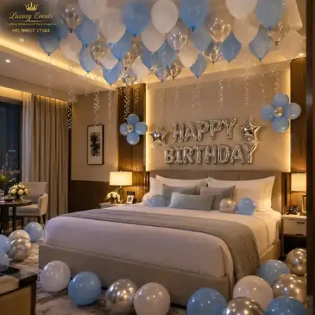 Pastel sky blue and metallic silver birthday hotel room decoration in DLF Phase 5 Gurugram by Luxury Events