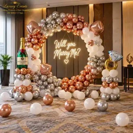 Marry Me setup in DLF Phase 1 Gurugram with rose gold balloon ring arch, neon sign and champagne bottle prop