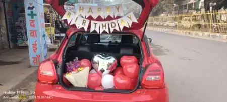 Romantic car boot surprise decoration with neon sign and rose petals, Gurugram
