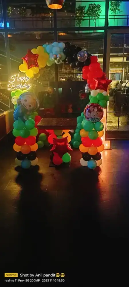 Minion theme balloon arch decoration at night, Gurugram